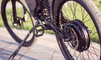 Electric bike motor wheel close up with pedal and rear shock absorber