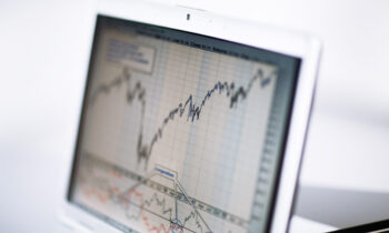 Businessman analyzing investment charts with laptop. Accounting