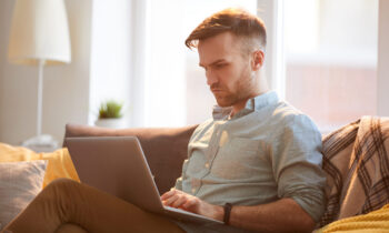 Handsome Man Using Laptop at Home