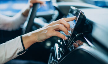 Woman touching screen in her car